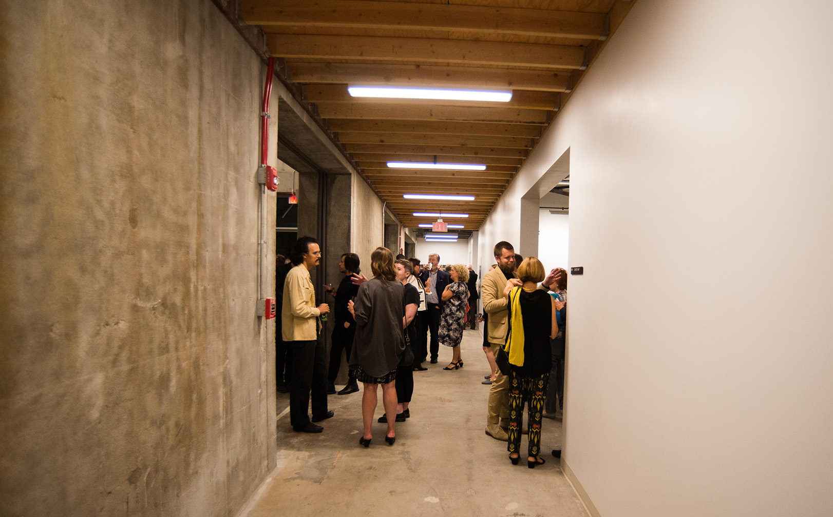 People talk in the hallway during an event